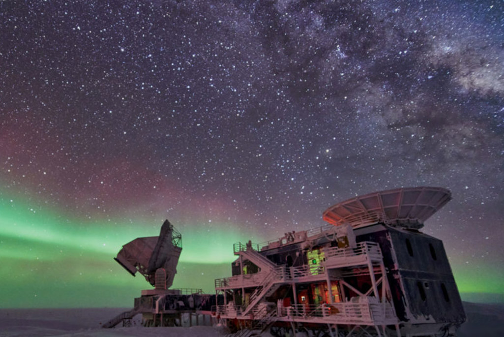 The aurora and milky way over a South Pole observatory.