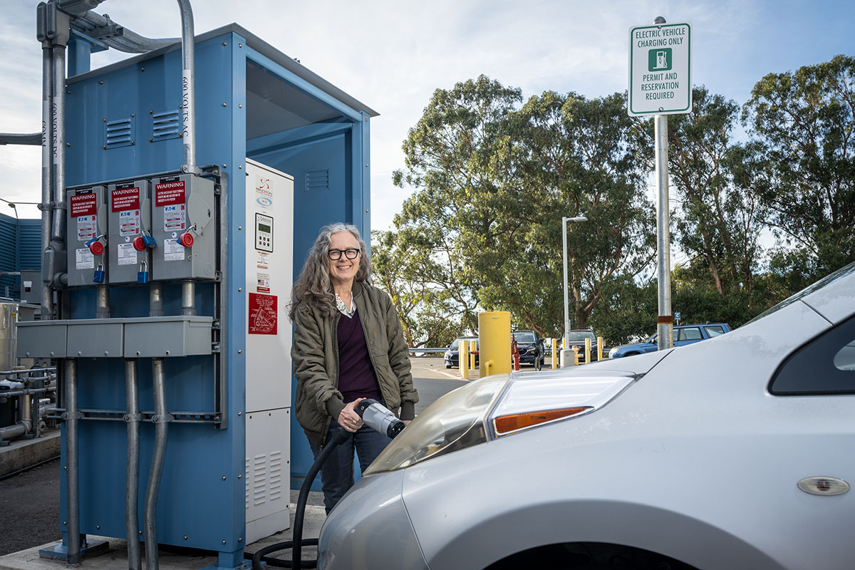 Cindy Regnier photographed at a bidirectional EV charging station at Lawrence Berkeley National Laboratory (Berkeley Lab).