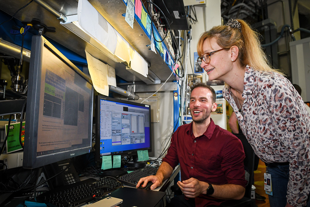 Carolin Sutter-Fella (standing), Staff Scientist, and Tim Kodalle, Postdoctoral Researcher, discuss their research at the Advanced Light Source (ALS).