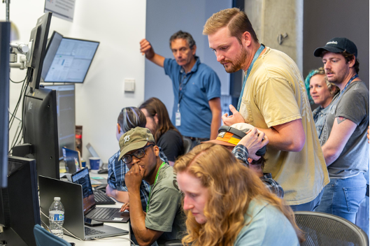 A team of scientists gathered at the Fermilab neutrino operations center.