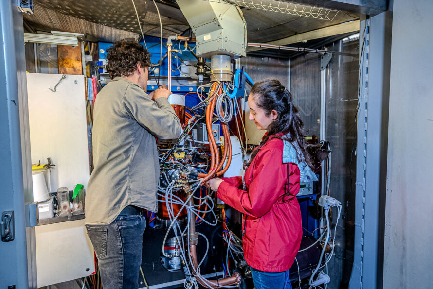 Two scientists work on VENUS, the ion source where the titanium-50 beam is created.