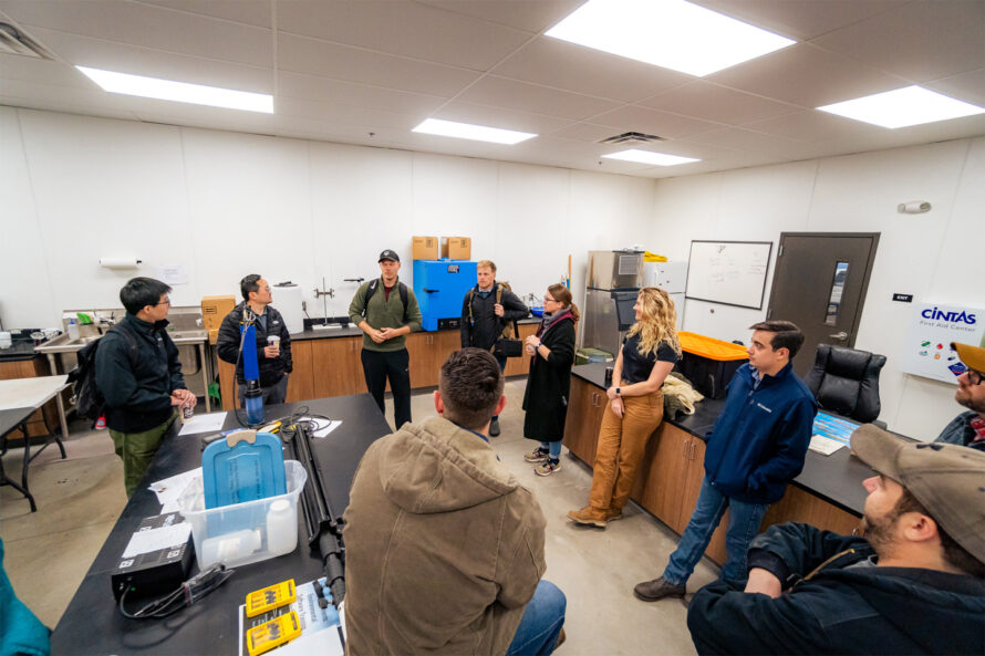 People gathered in an office space in discussion.