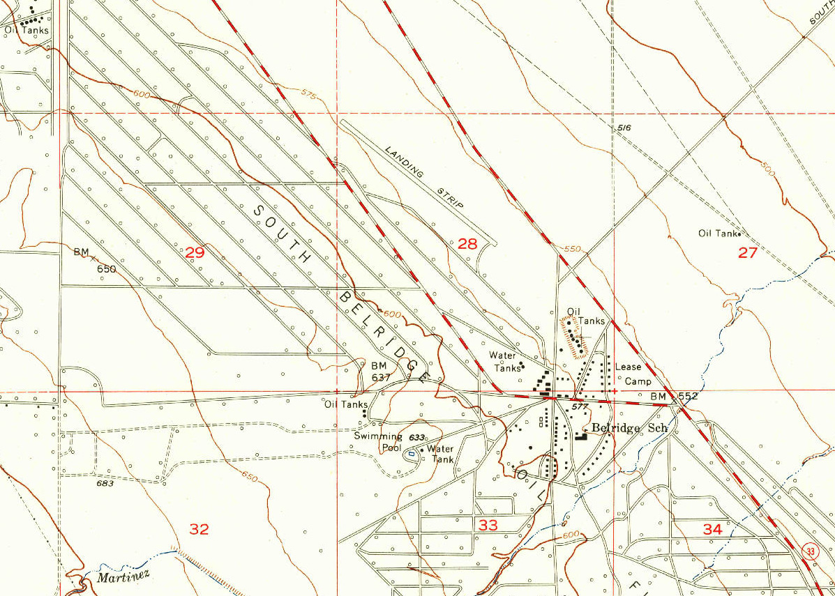 Topographic quadrangle map with hollow black circles marking oil wells.