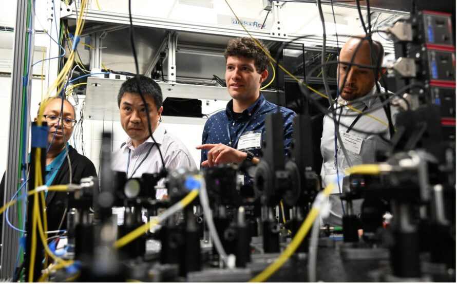 Four people touring the Quantum Network Facility.