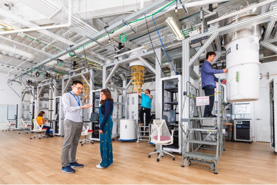 Five individuals working on separate projects at the SQMS Quantum Garage at Fermilab.