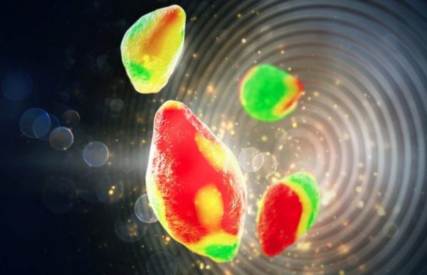 Illustration of lithium-ion battery particles shaded in tones of red, yellow, and green under the illumination of an X-ray beam depicted as nested circles in a golden hue.