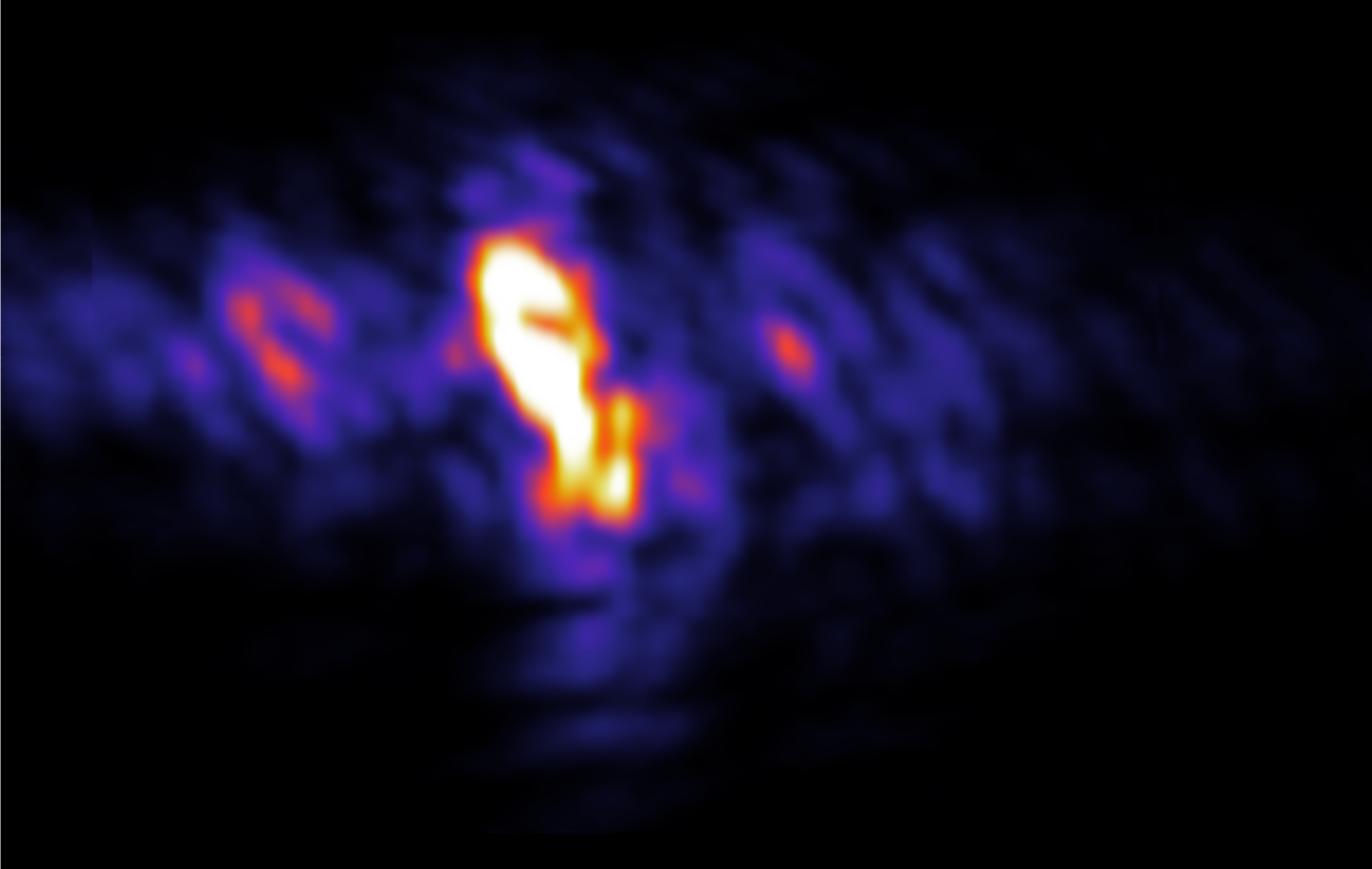 On a black background, an irregular purple shape with one large oval mass and two smaller clumps on either side, with orange highlights in the center of each shape, though the highlight in the middle is much larger and has white in its center.