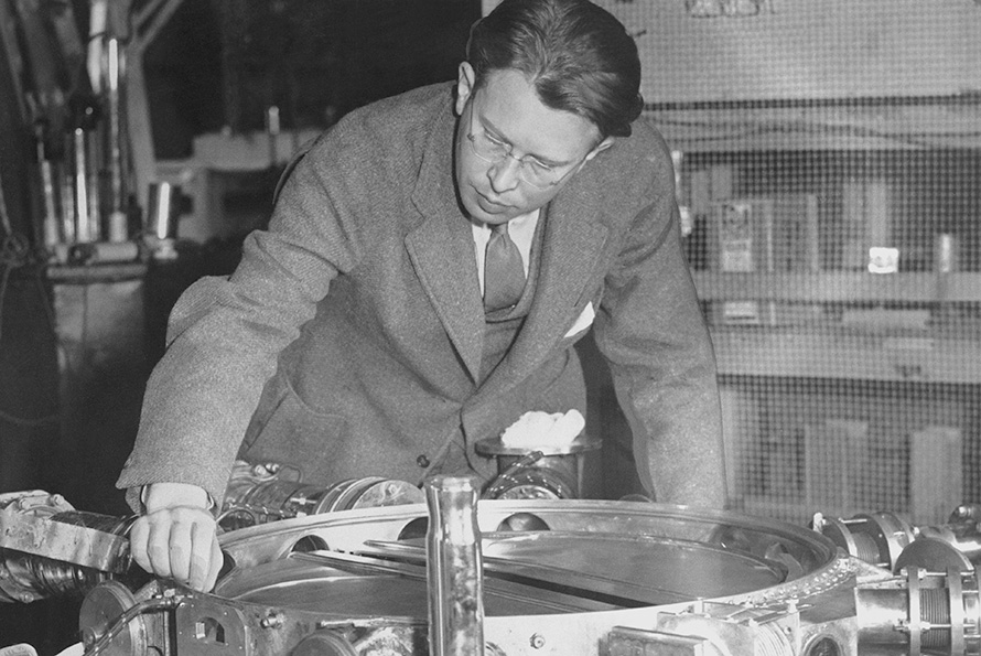 E.O. Lawrence inspects part of the 37-1/2-inch cyclotron, circa 1935.