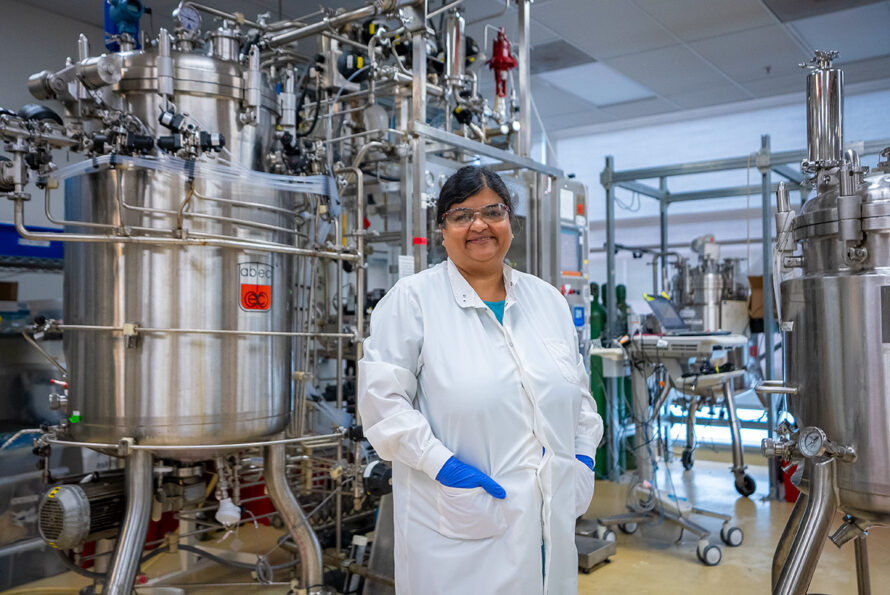 Deepti Tanjori in front of bioreactors.