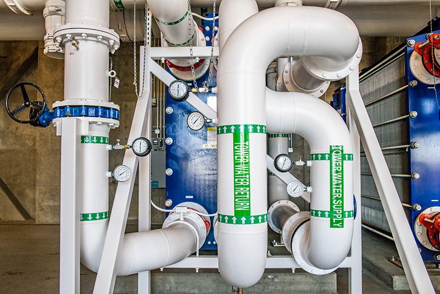 Image of large white pipes in a supercomputer facility.