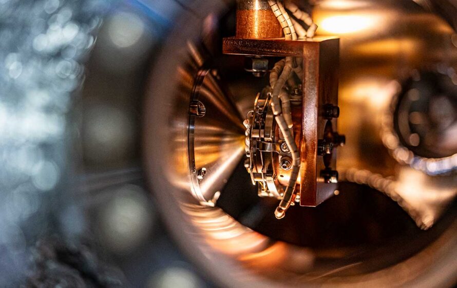 A closeup view of an amber colored sample holder from outside of a viewing window.