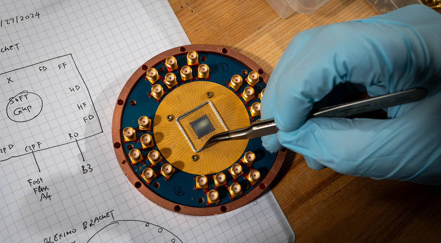 A round copper and teal-colored plate on top of a technical sketch.