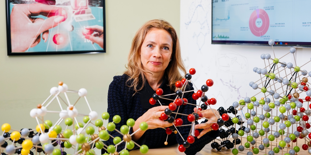 Persson in her office surrounded by ball-and-stick models of molecules