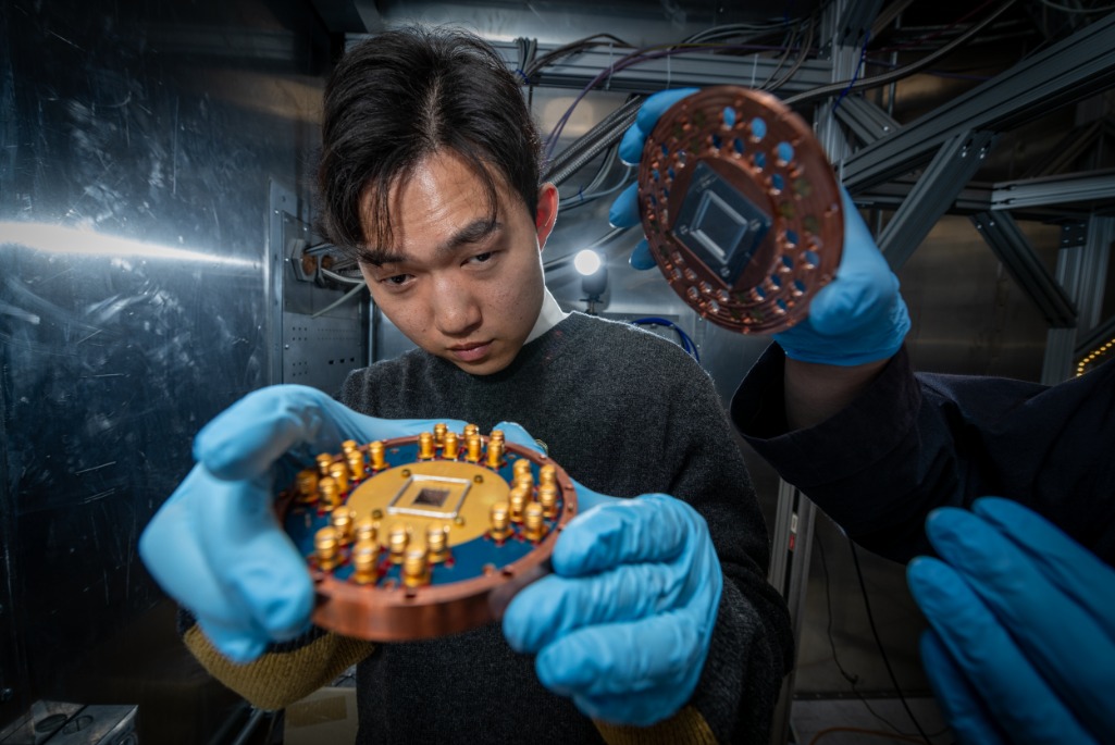 Researcher in blue gloves inspects a Sample Box.