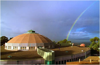 The Advanced Light Source with a rainbow in the background.