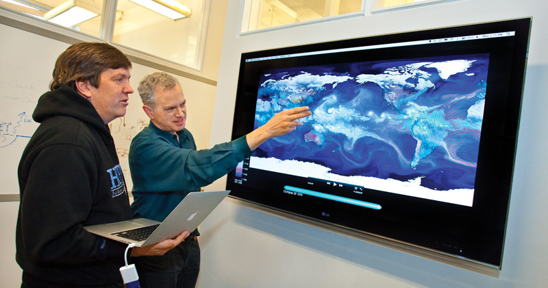 Berkeley Lab scientists Michael Wehner (left) and William Collins look at a climate visualization. (Photo credit Roy Kaltschmidt/Berkeley Lab)